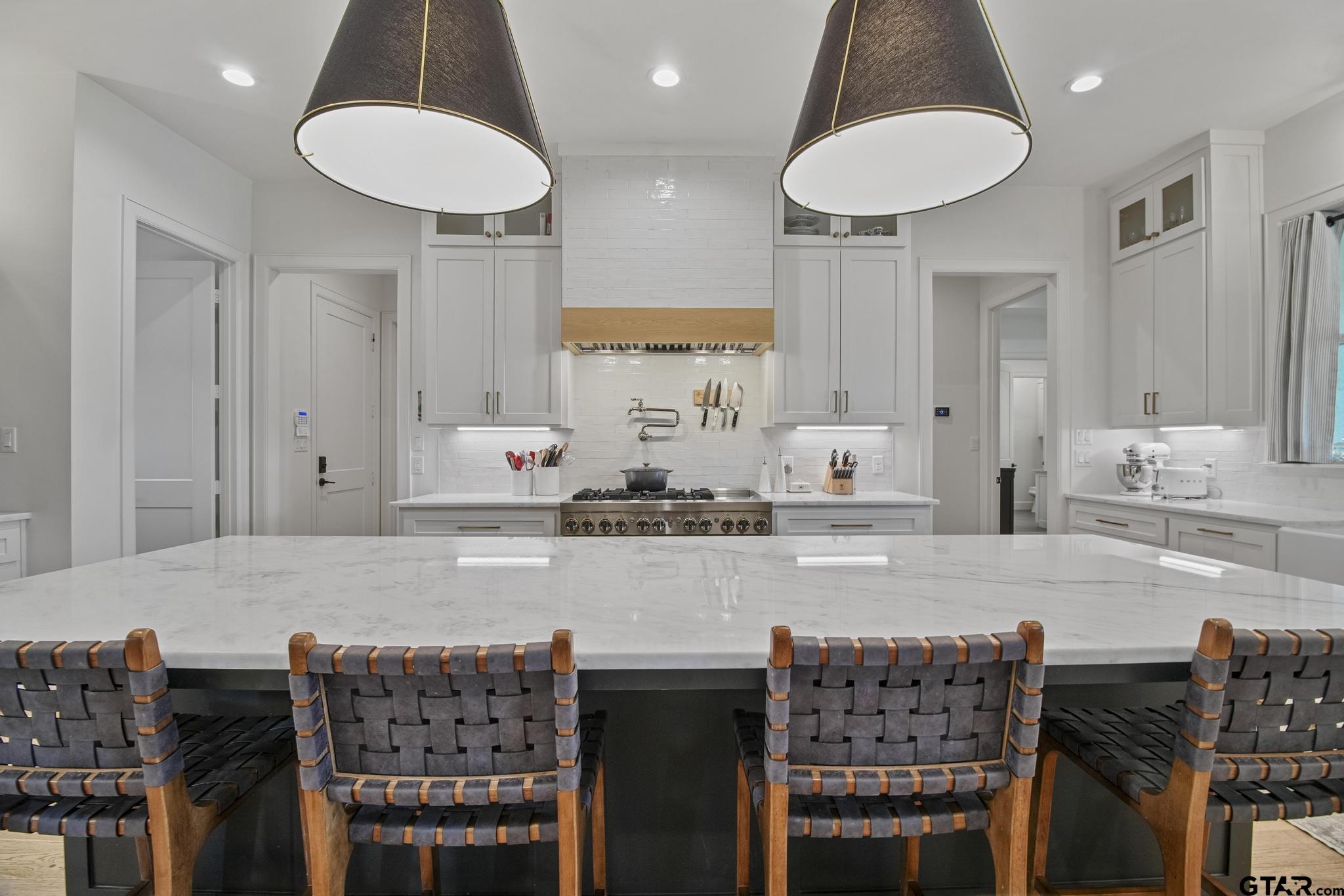 1242 Colt Lane Tyler, TX 75703 - Photo 13 of 47 a kitchen with stainless steel appliances granite countertop a table chairs sink and cabinets