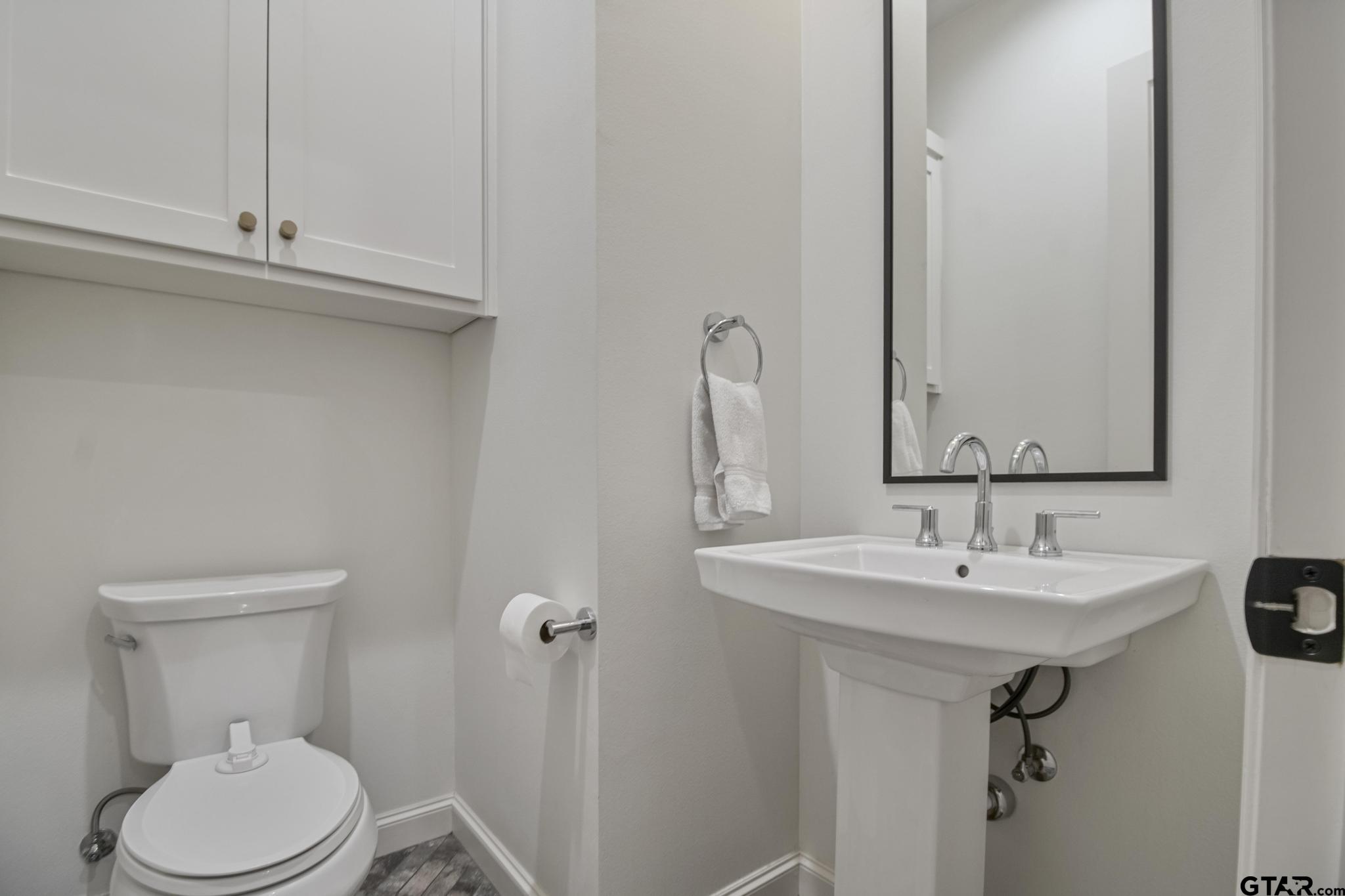1242 Colt Lane Tyler, TX 75703 - Photo 18 of 47 a bathroom with a sink a toilet and mirror