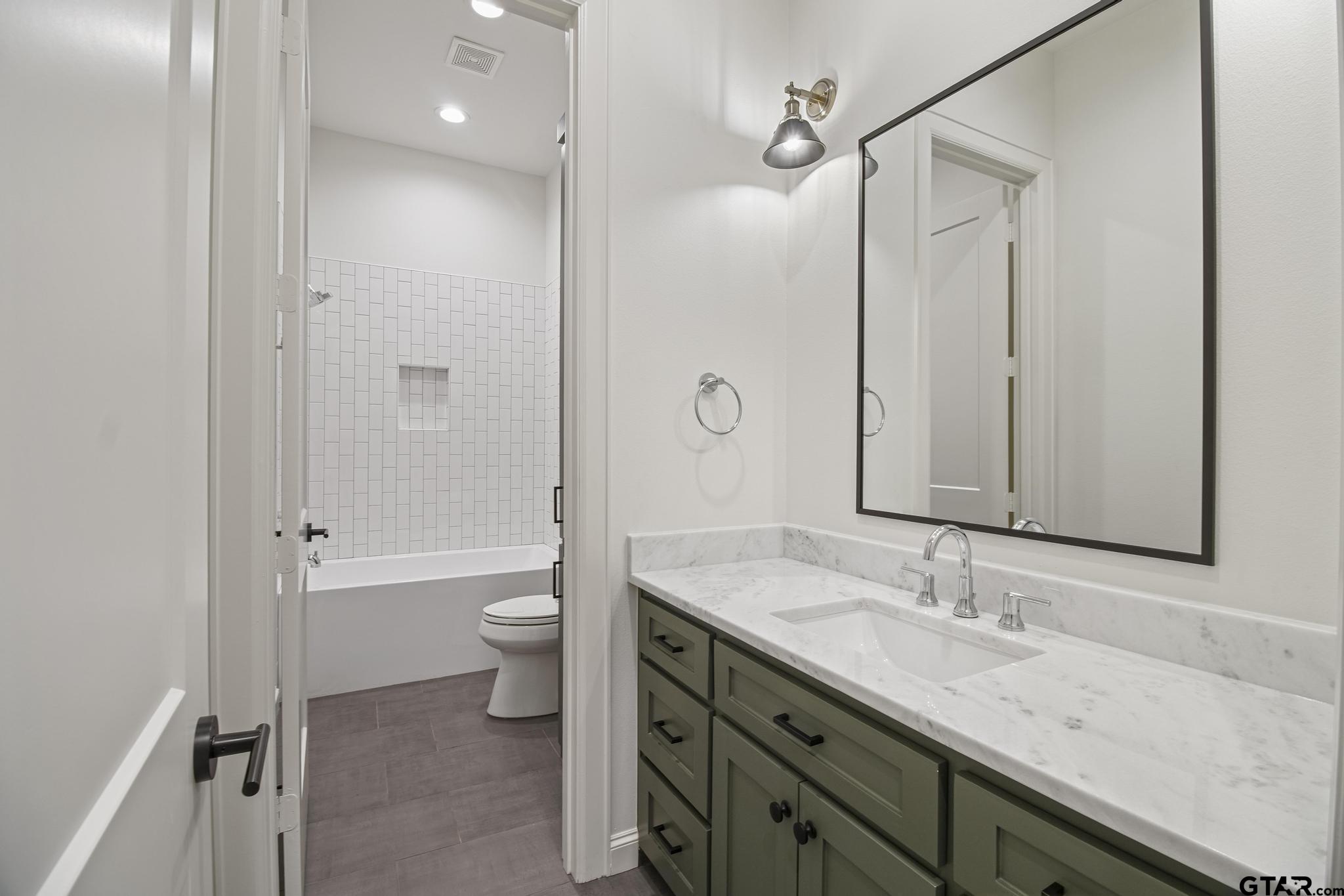 1242 Colt Lane Tyler, TX 75703 - Photo 24 of 47 a bathroom with a granite countertop sink toilet and shower