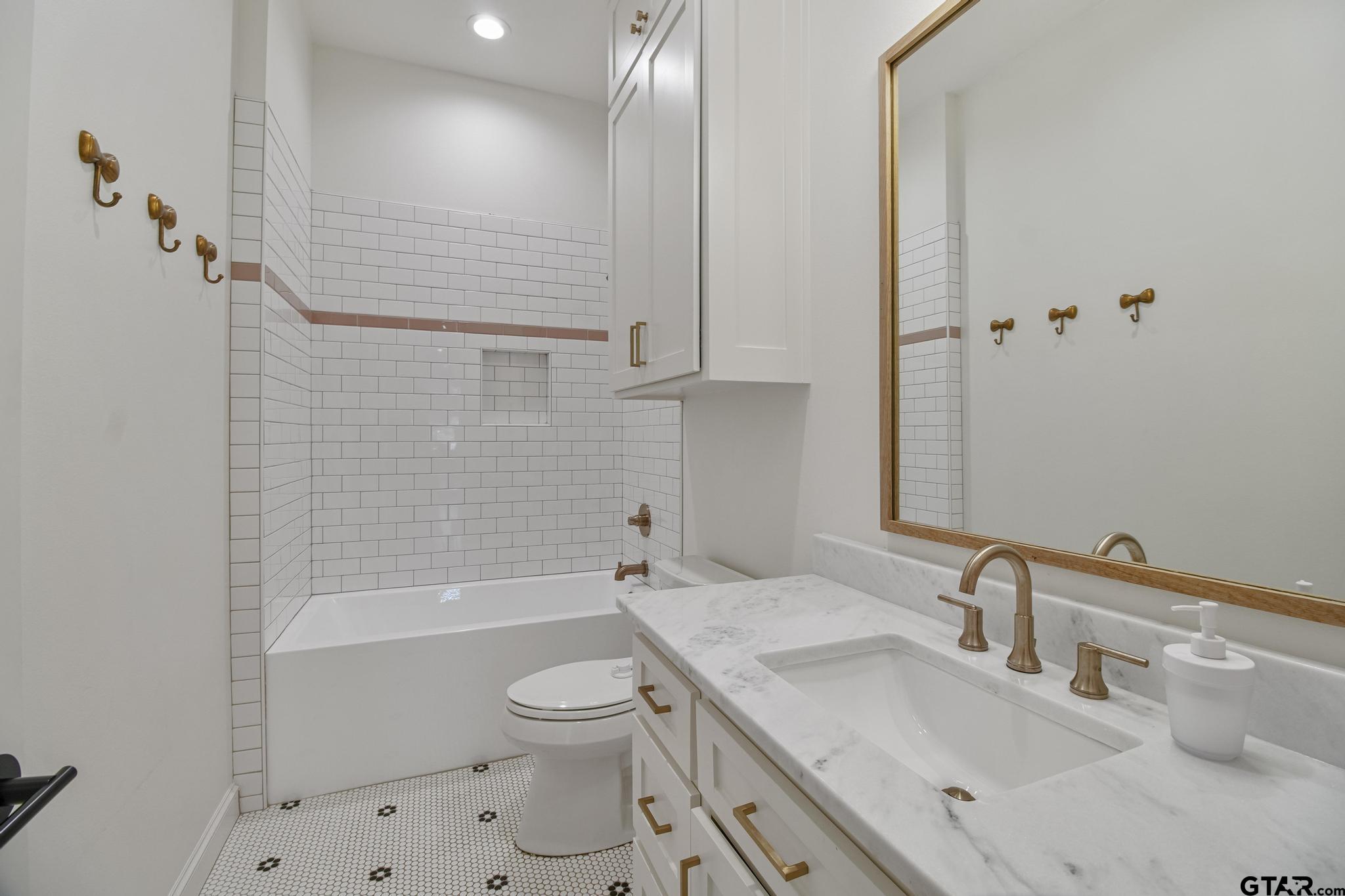 1242 Colt Lane Tyler, TX 75703 - Photo 25 of 47 a bathroom with a sink a toilet and shower