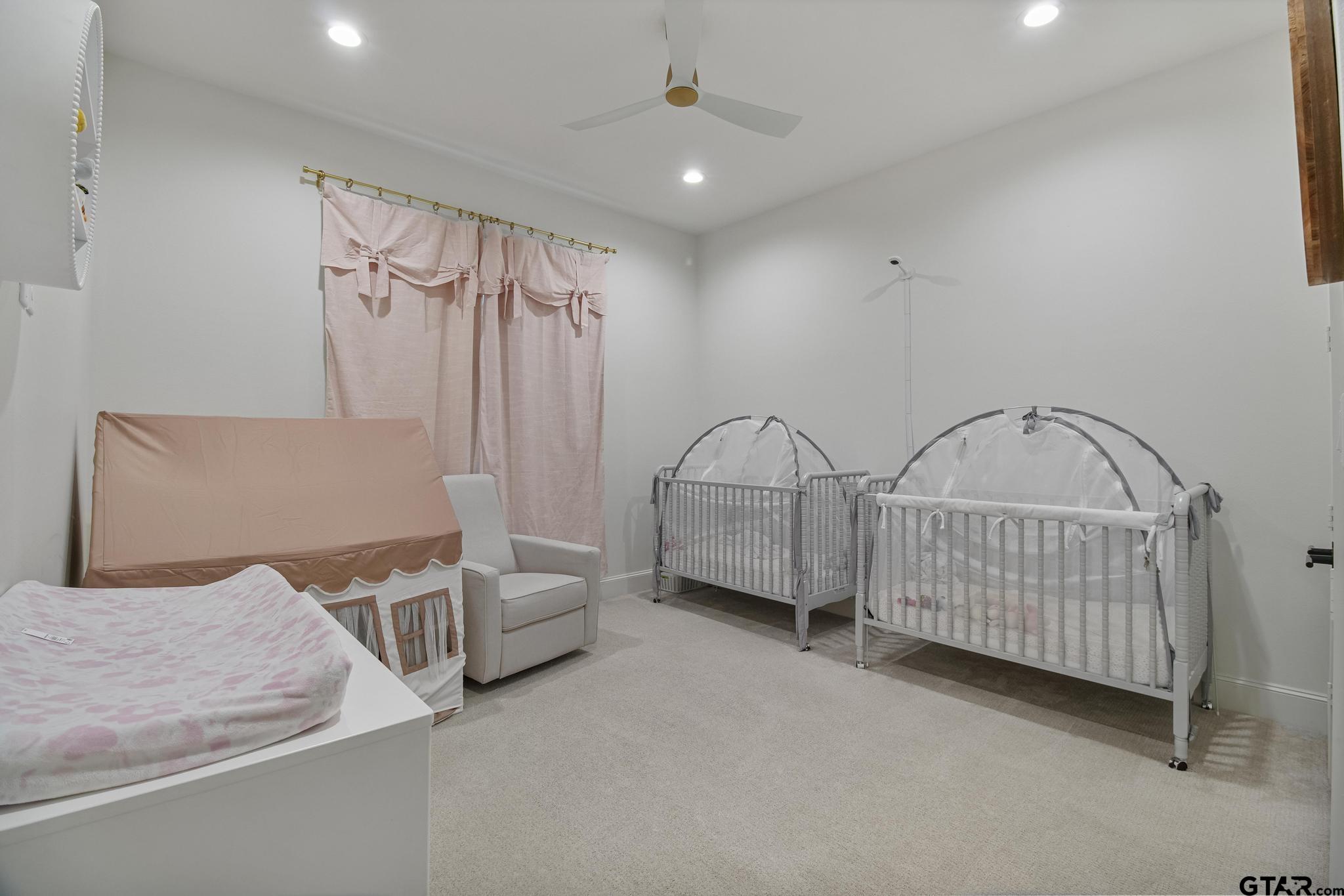 1242 Colt Lane Tyler, TX 75703 - Photo 26 of 47 a bedroom with furniture and a chandelier