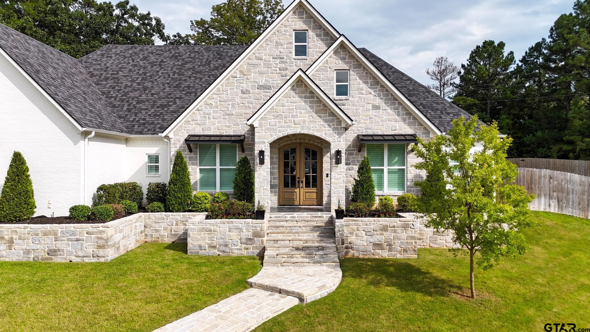 1242 Colt Lane Tyler, TX 75703 - Photo 3 of 47 a front view of a house with garden
