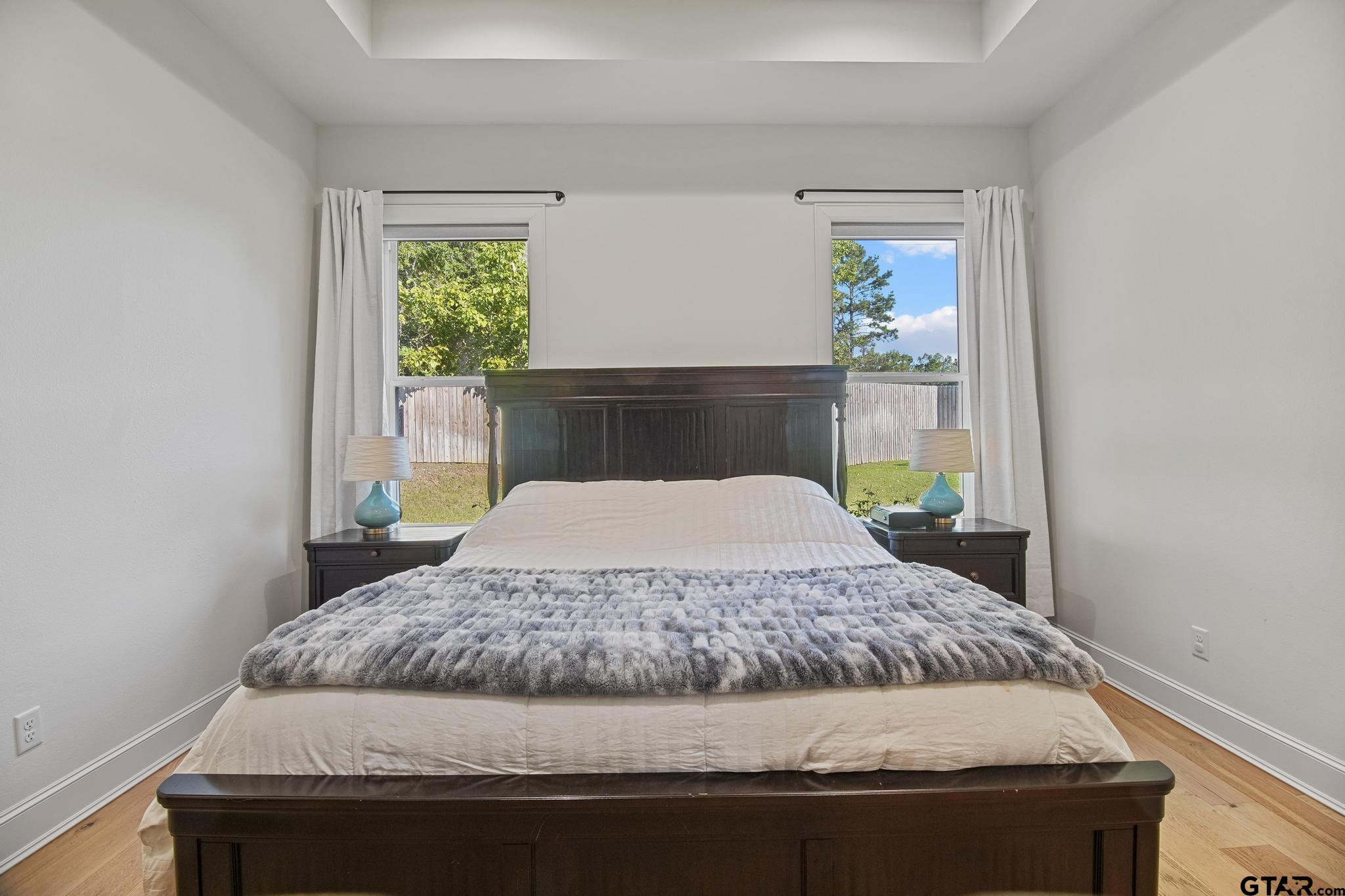 1242 Colt Lane Tyler, TX 75703 - Photo 31 of 47 a bedroom with a bed and two windows