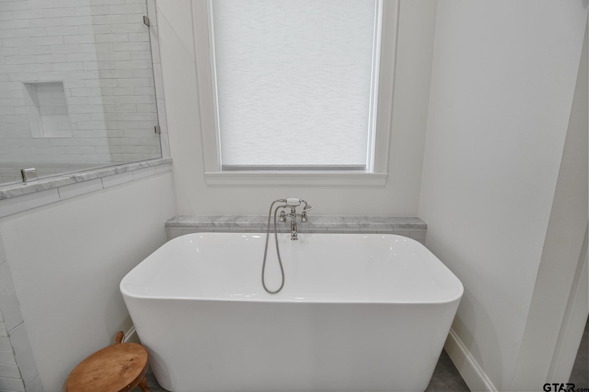 1242 Colt Lane Tyler, TX 75703 - Photo 33 of 47 a white bath tub sitting in a bathroom