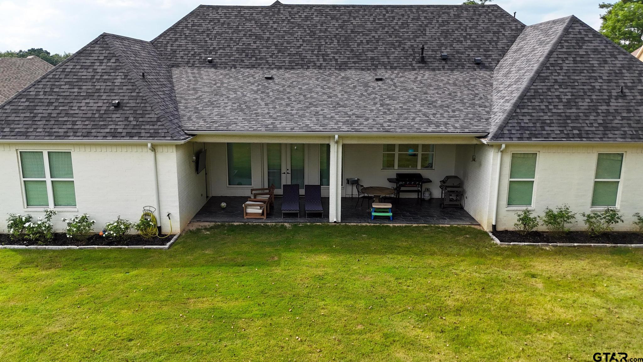 1242 Colt Lane Tyler, TX 75703 - Photo 36 of 47 a view of a house with backyard porch and sitting area