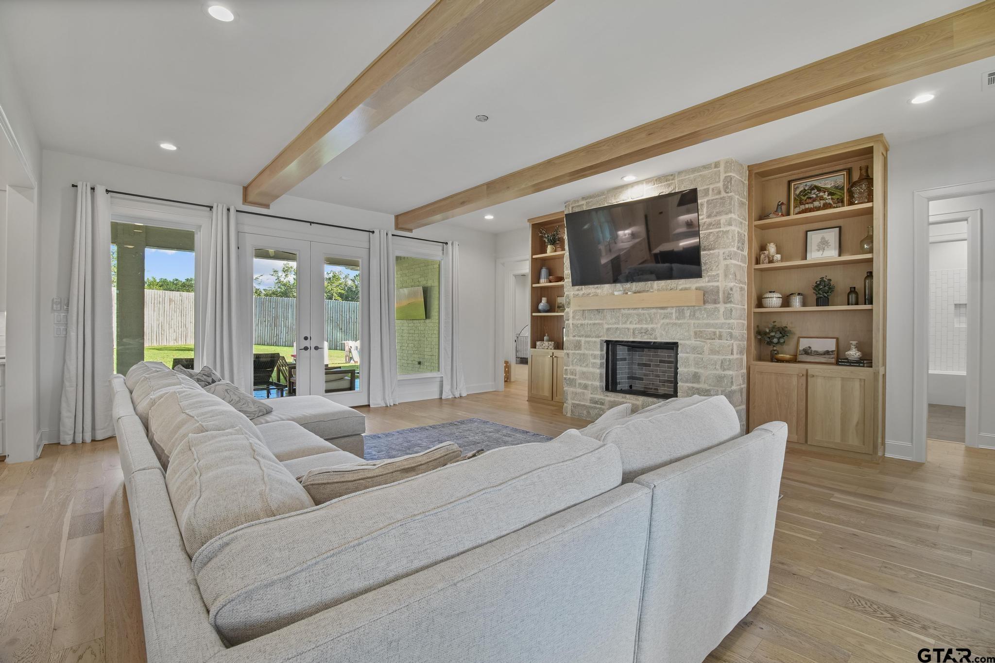 1242 Colt Lane Tyler, TX 75703 - Photo 6 of 47 a living room with fireplace furniture and a flat screen tv