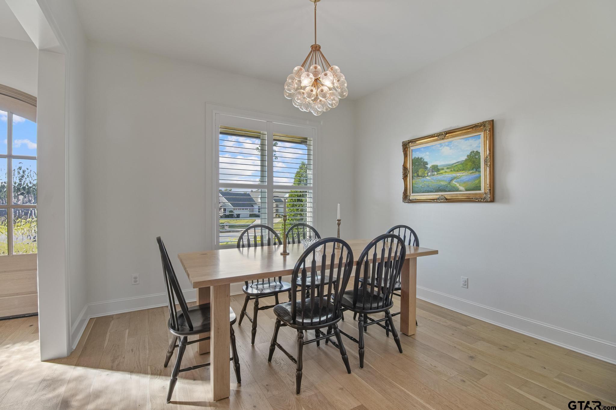 1242 Colt Lane Tyler, TX 75703 - Photo 7 of 47 a view of a dining room with furniture window and wooden floor