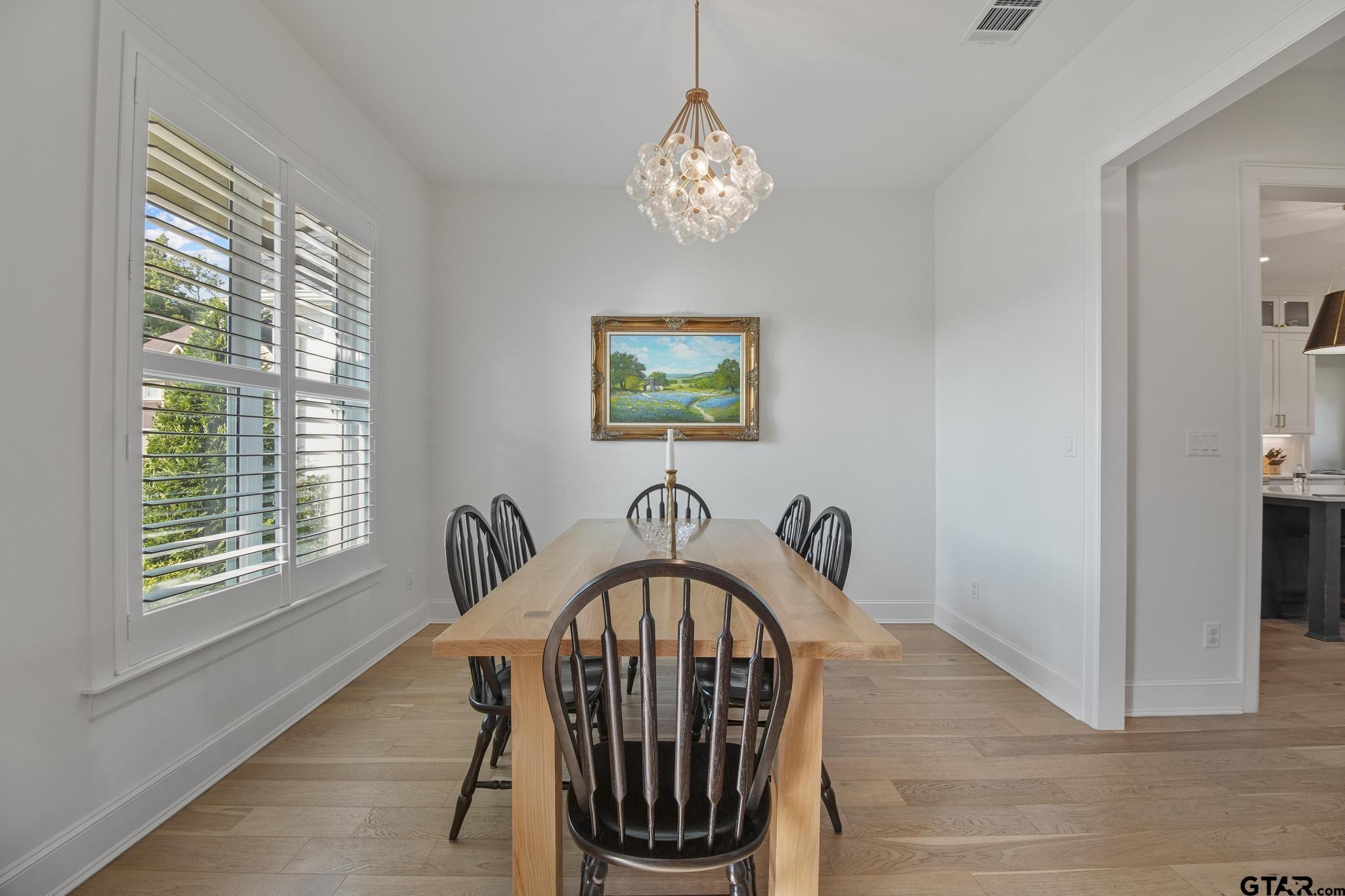 1242 Colt Lane Tyler, TX 75703 - Photo 8 of 47 a view of a dining room with furniture window and wooden floor
