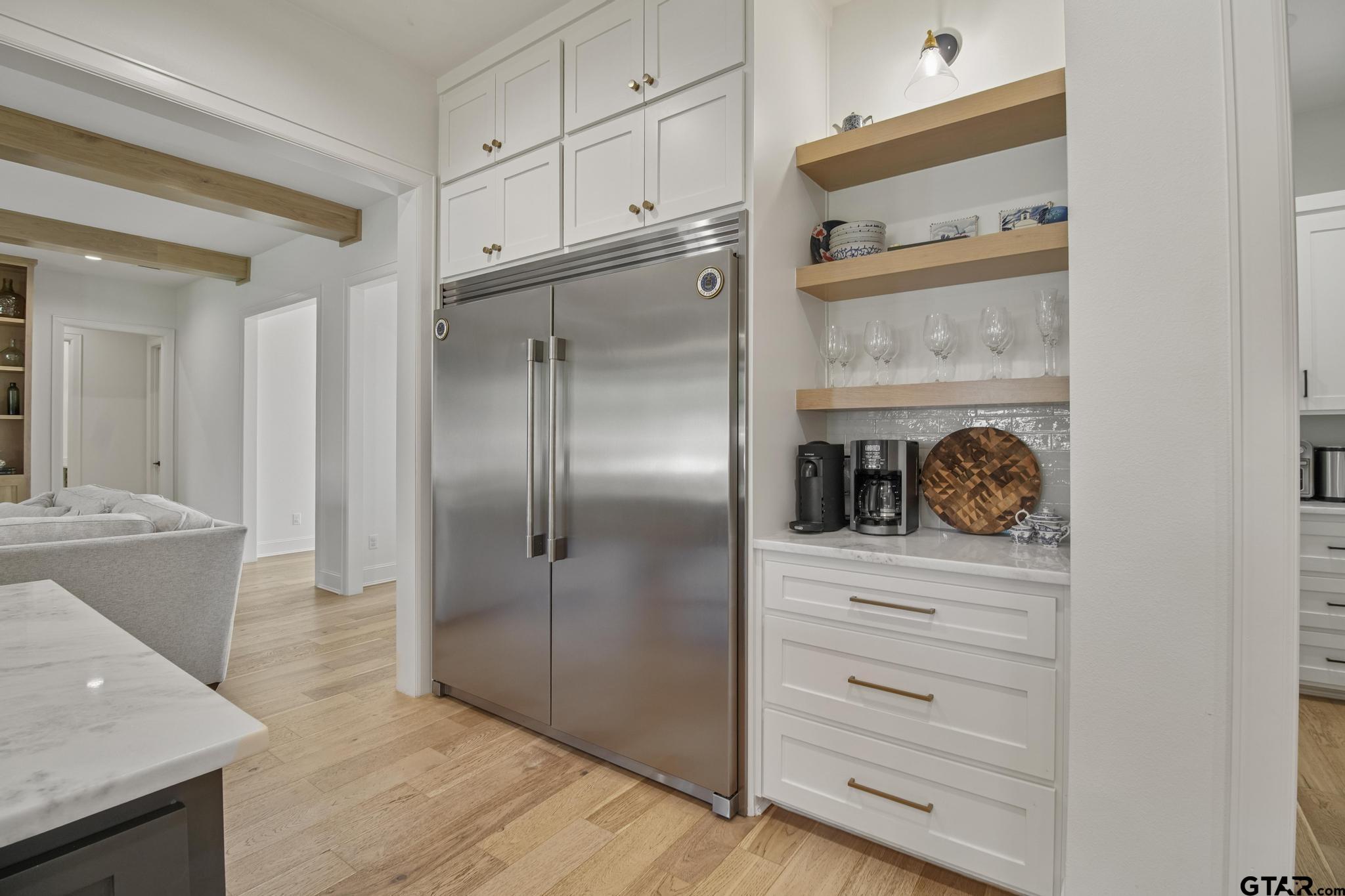 1242 Colt Lane Tyler, TX 75703 - Photo 10 of 47 a kitchen with a refrigerator and cabinets