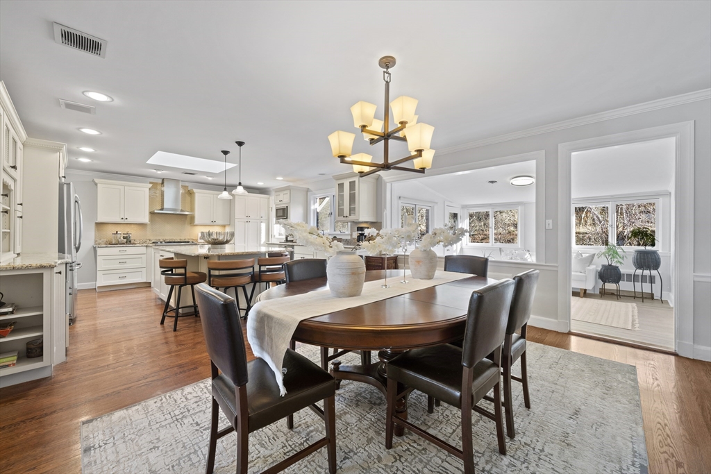 447 Dudley Road Newton, MA 02459 - Photo 14 of 42 a view of a dining room with furniture wooden floor and chandelier