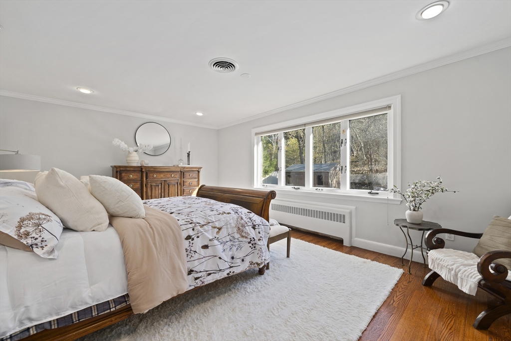447 Dudley Road Newton, MA 02459 - Photo 17 of 42 a bedroom with a bed a table and chair with the large windows