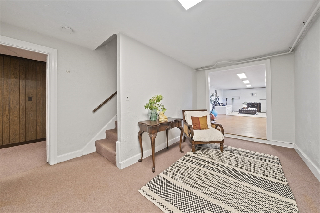 447 Dudley Road Newton, MA 02459 - Photo 27 of 42 a living room with furniture a rug and white walls