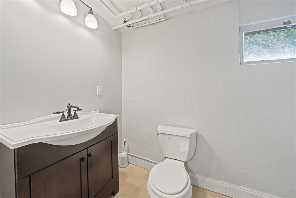 447 Dudley Road Newton, MA 02459 - Photo 34 of 42 a bathroom with a sink a toilet and a mirror