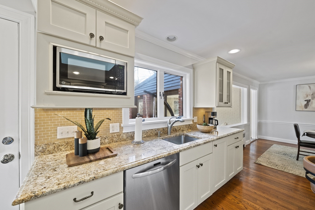 447 Dudley Road Newton, MA 02459 - Photo 7 of 42 a kitchen with stainless steel appliances granite countertop a sink a stove and cabinets