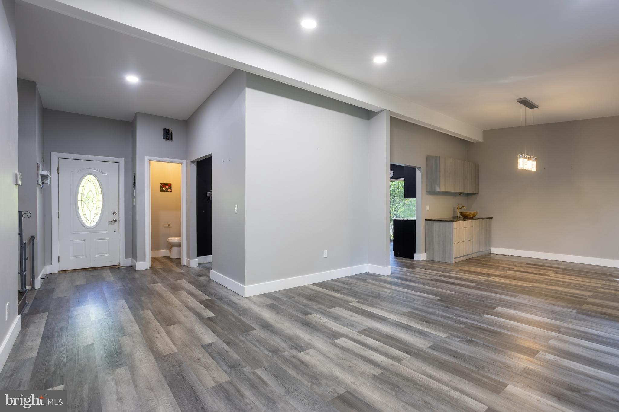 3207 Midfield Road Pikesville, MD 21208 - Photo 6 of 45 a view of an empty room with wooden floor and a window