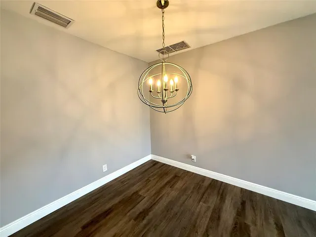 a view of a room with wooden floor and fan