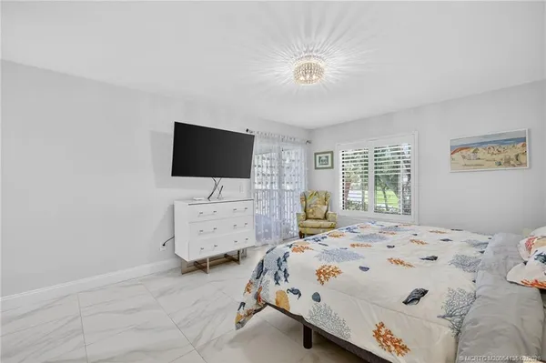 a bedroom with a bed and flat screen tv