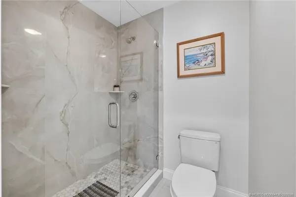 a bathroom with a toilet and a shower