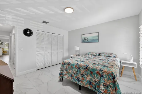 a bedroom with a bed and a view of kitchen