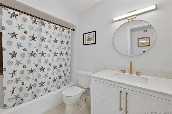 a bathroom with a sink toilet and a mirror