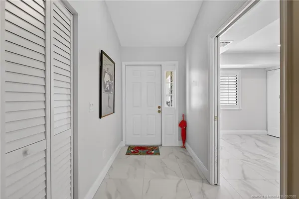a view of an entryway with wooden floor