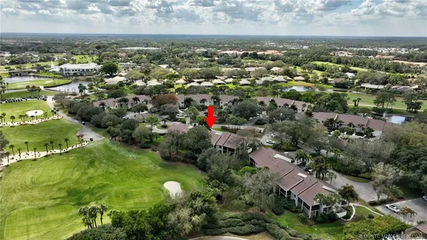 an aerial view of house with yard and outdoor seating