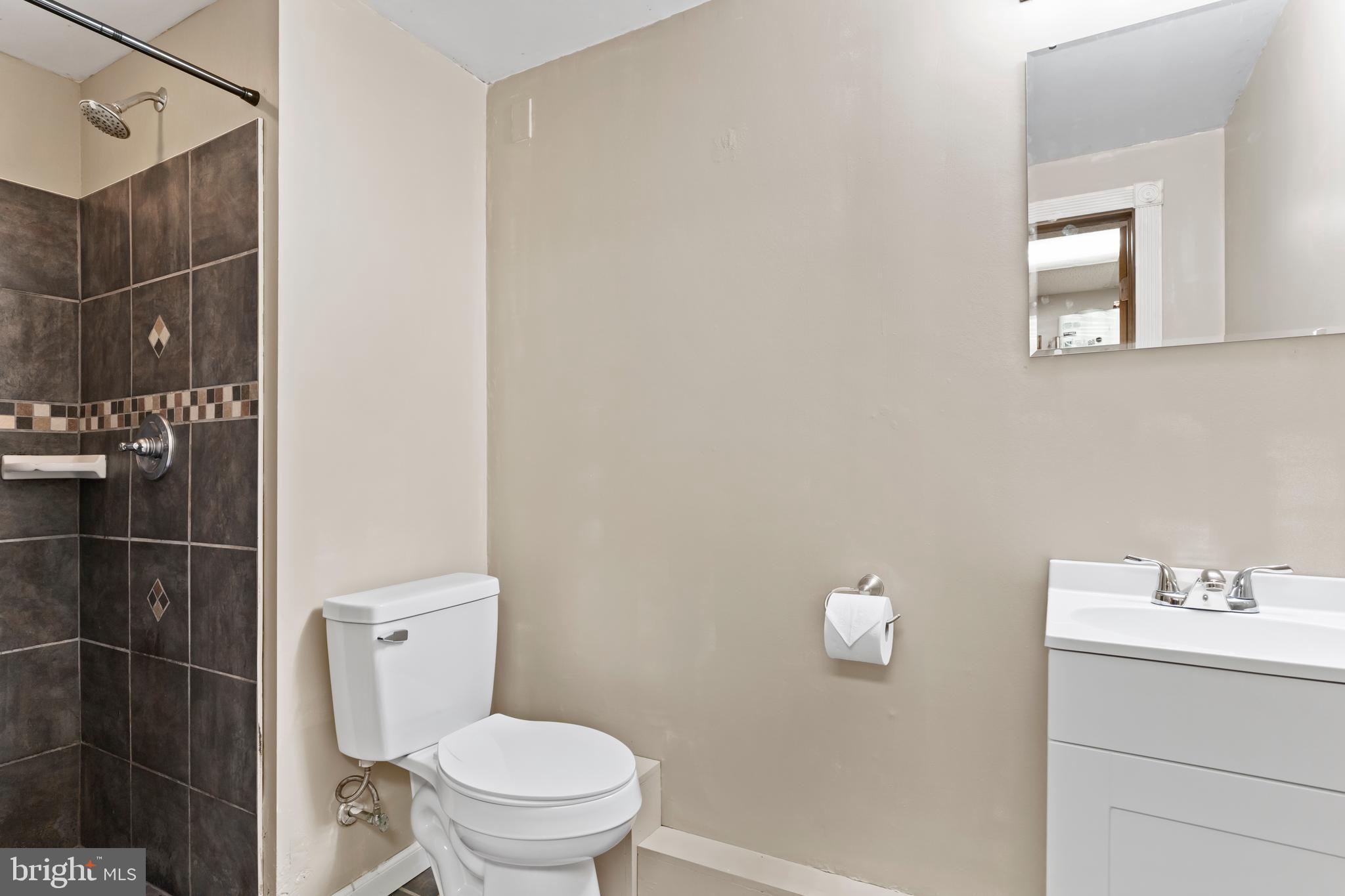 410 Belvedere Road Harrisburg, PA 17109 - Photo 23 of 29 a white toilet sitting next to a bathroom sink and vanity