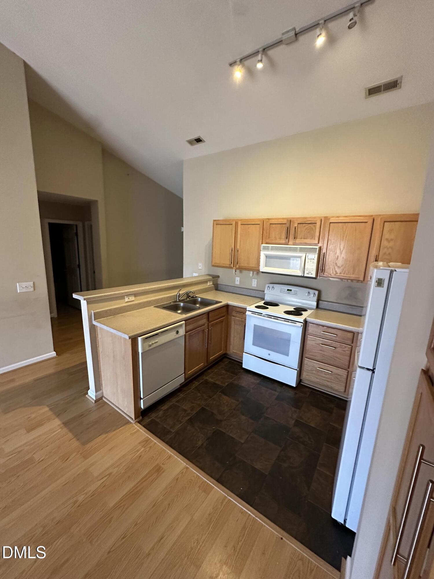 1901 Trailwood Heights Lane, Unit 302 Raleigh, NC 27603 - Photo 14 of 16 a kitchen with a stove and a microwave