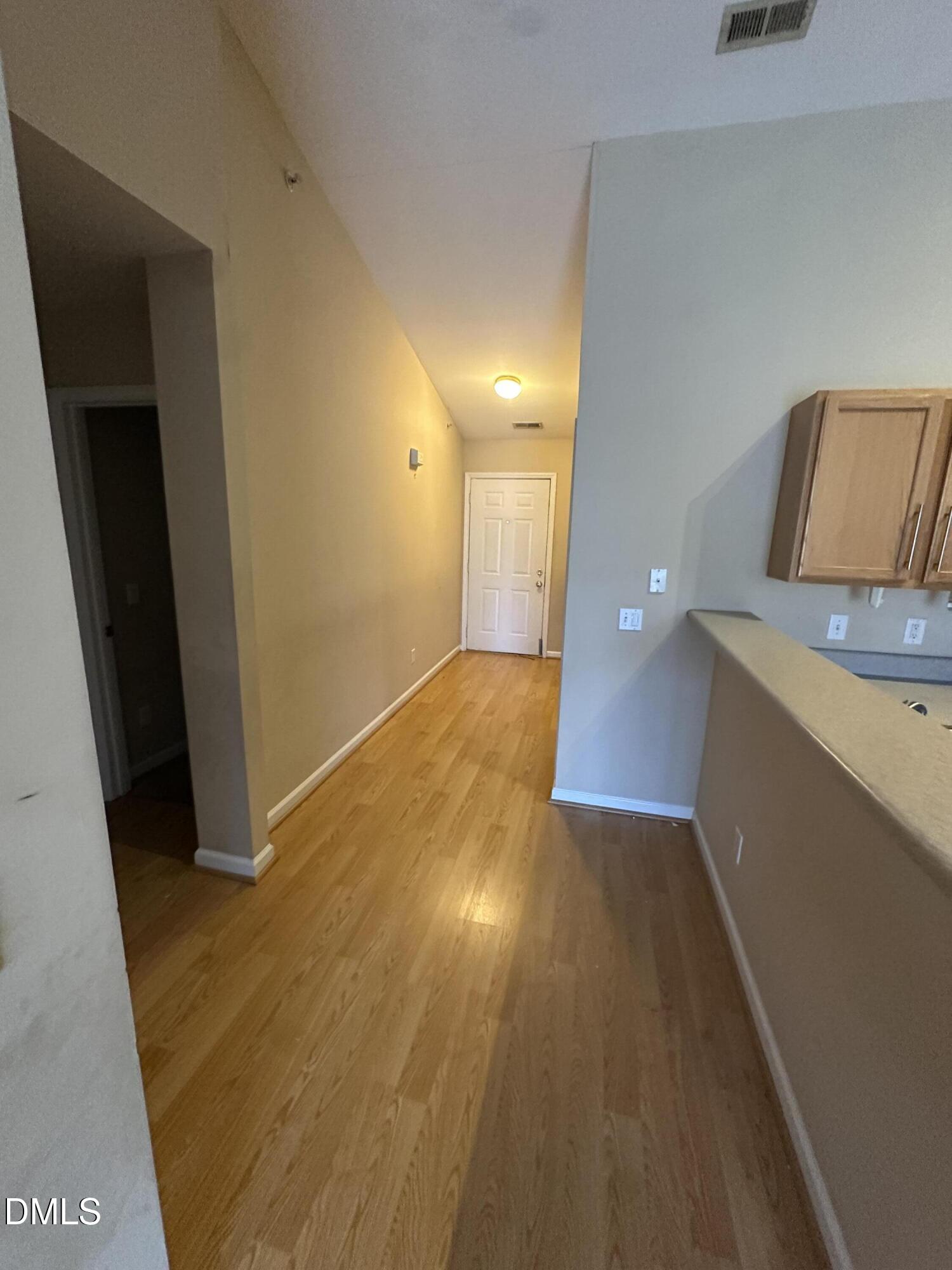 1901 Trailwood Heights Lane, Unit 302 Raleigh, NC 27603 - Photo 2 of 16 a view of a room with wooden floor and cabinet