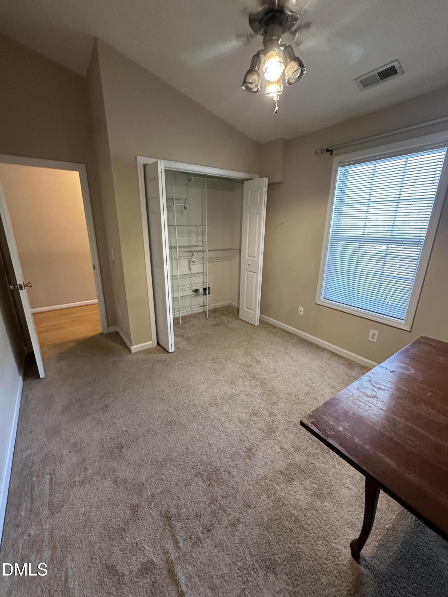 1901 Trailwood Heights Lane, Unit 302 Raleigh, NC 27603 - Photo 4 of 16 a view of an empty room with a window