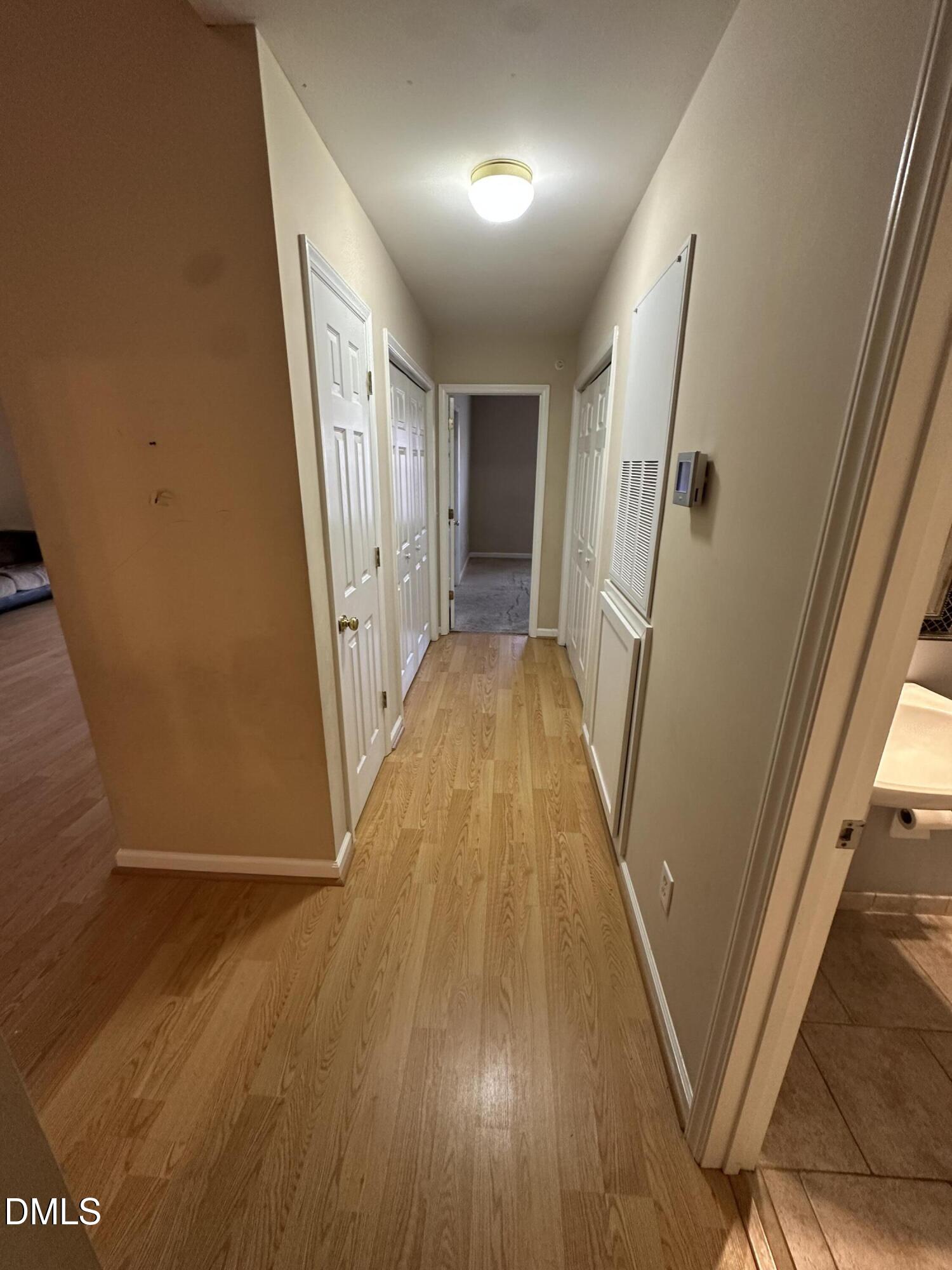 1901 Trailwood Heights Lane, Unit 302 Raleigh, NC 27603 - Photo 8 of 16 a view of a hallway with wooden floor