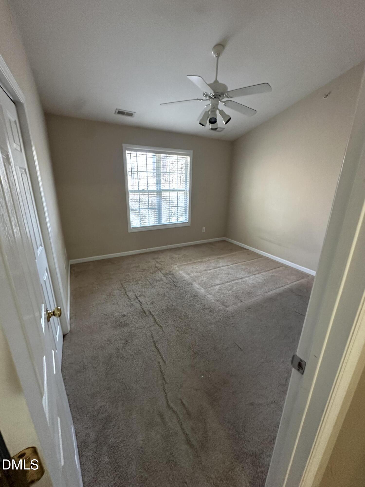 1901 Trailwood Heights Lane, Unit 302 Raleigh, NC 27603 - Photo 9 of 16 a view of an empty room with a window