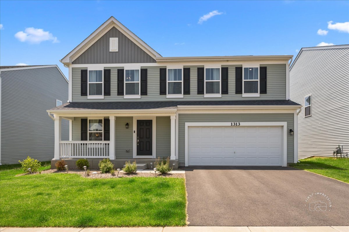 1313 Endicott Road South Elgin, IL 60177 - Photo 1 of 20 a front view of a house with a yard and garage