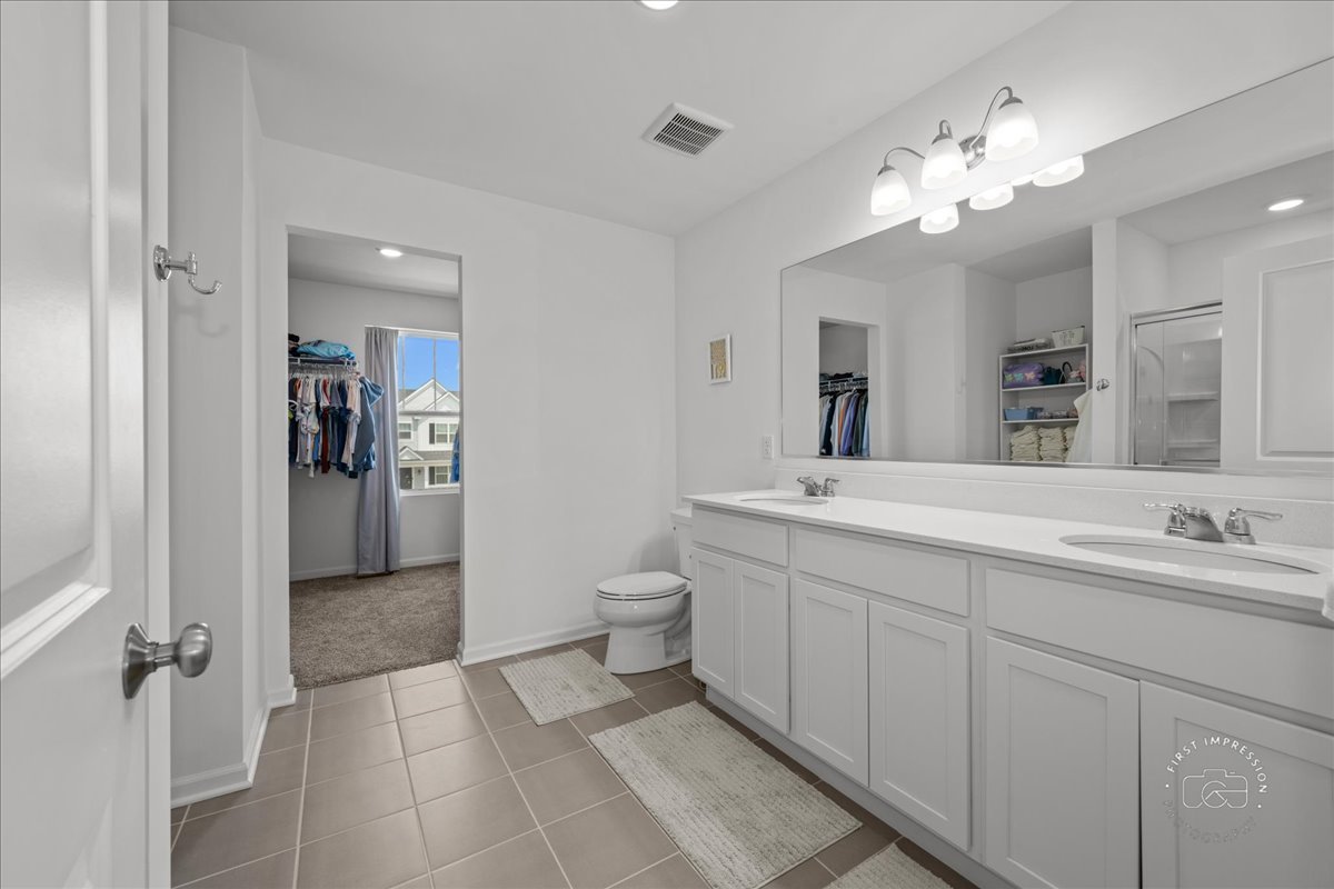 1313 Endicott Road South Elgin, IL 60177 - Photo 14 of 20 a spacious bathroom with a double vanity sink mirror and toilet
