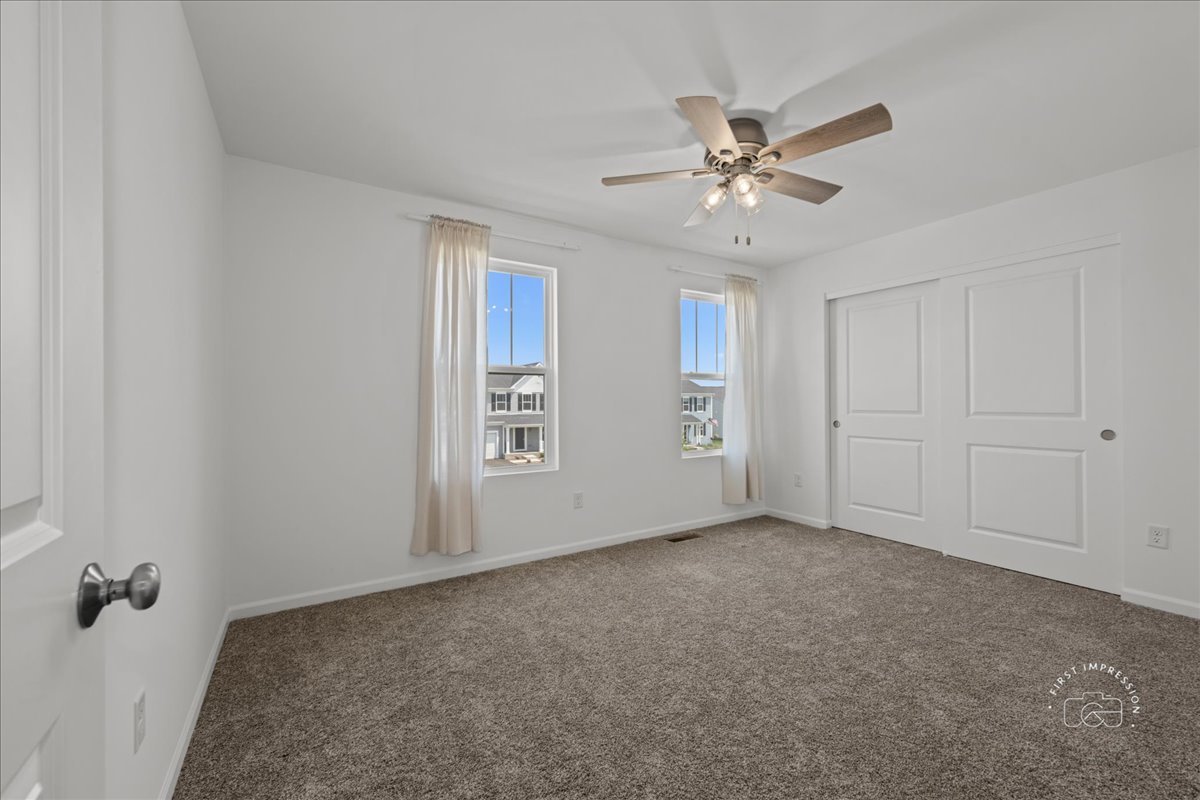 1313 Endicott Road South Elgin, IL 60177 - Photo 18 of 20 an empty room with windows and fan