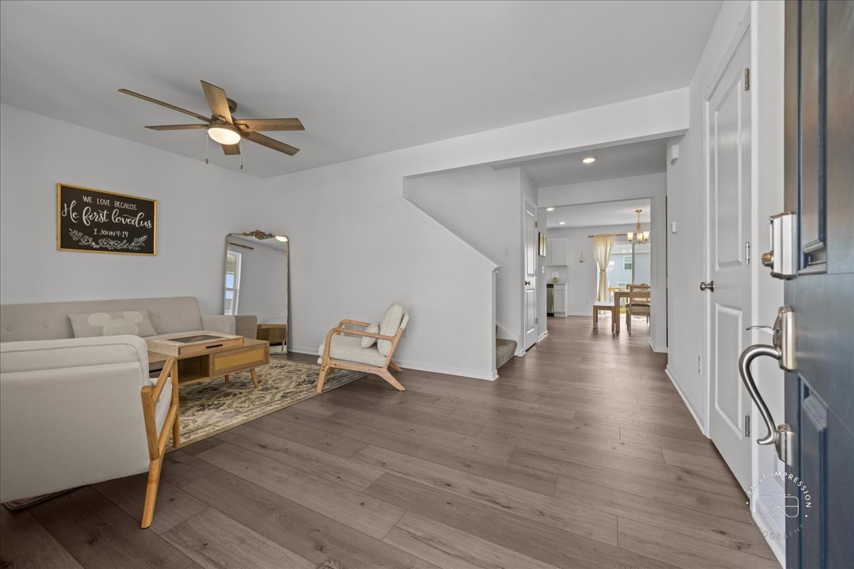 1313 Endicott Road South Elgin, IL 60177 - Photo 3 of 20 a view of a livingroom with a hardwood floor and a ceiling fan