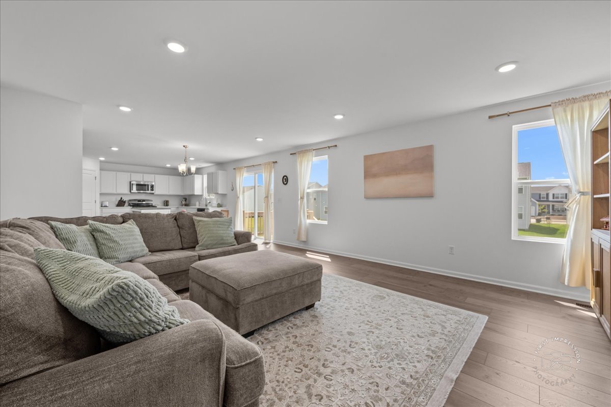 1313 Endicott Road South Elgin, IL 60177 - Photo 8 of 20 a living room with couches and kitchen view