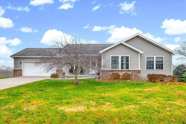 a view of a house with a backyard and a tree