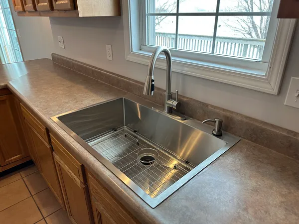 an empty room with an entrance and mirror