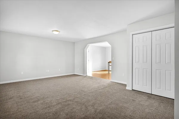 an empty room with a ceiling fan and a window