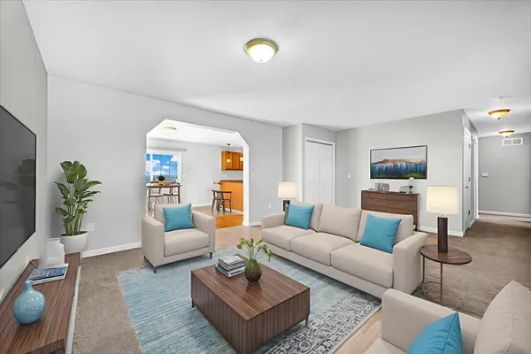 a living room with furniture and wooden floor