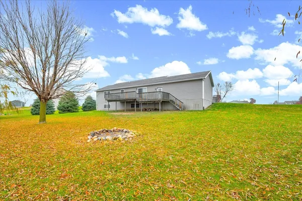 a living room with stainless steel appliances kitchen island granite countertop furniture and a wooden floor