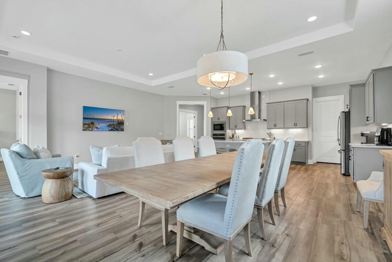 117 River Rise Way Watersound, FL 32461 - Photo 2 of 14 a view of a dining room with furniture and wooden floor
