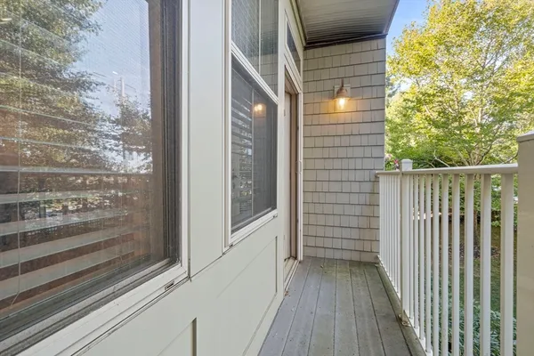 a view of a balcony with wooden floor and fence