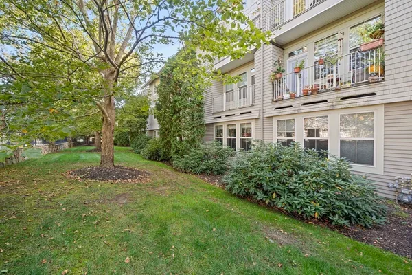 a pathway of a house with a yard