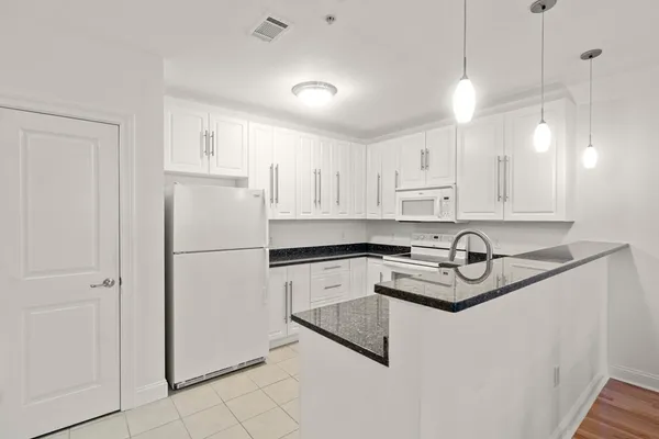 a white refrigerator freezer sitting inside of a kitchen