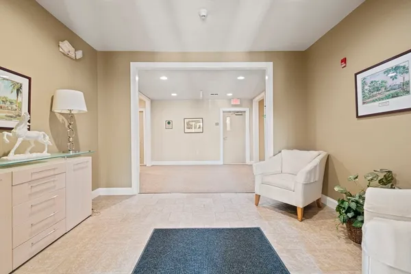 a spacious bathroom with a tub shower and mirror