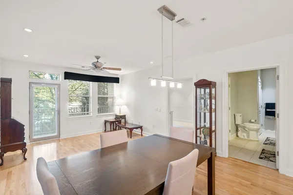a dining room with furniture and wooden floor
