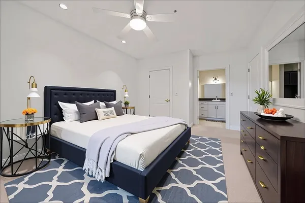 a spacious bedroom with a bed and a chandelier