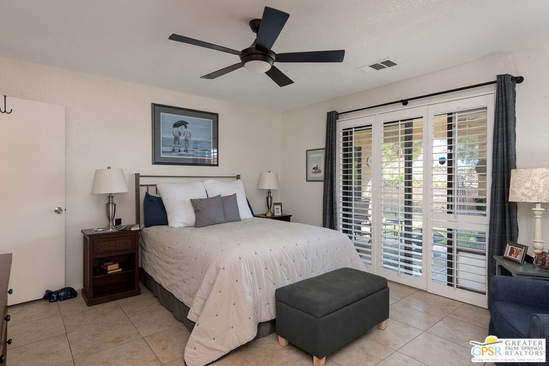 9760 Capiland Road Desert Hot Springs, CA 92240 - Photo 11 of 16 a bedroom with a bed couch and a window